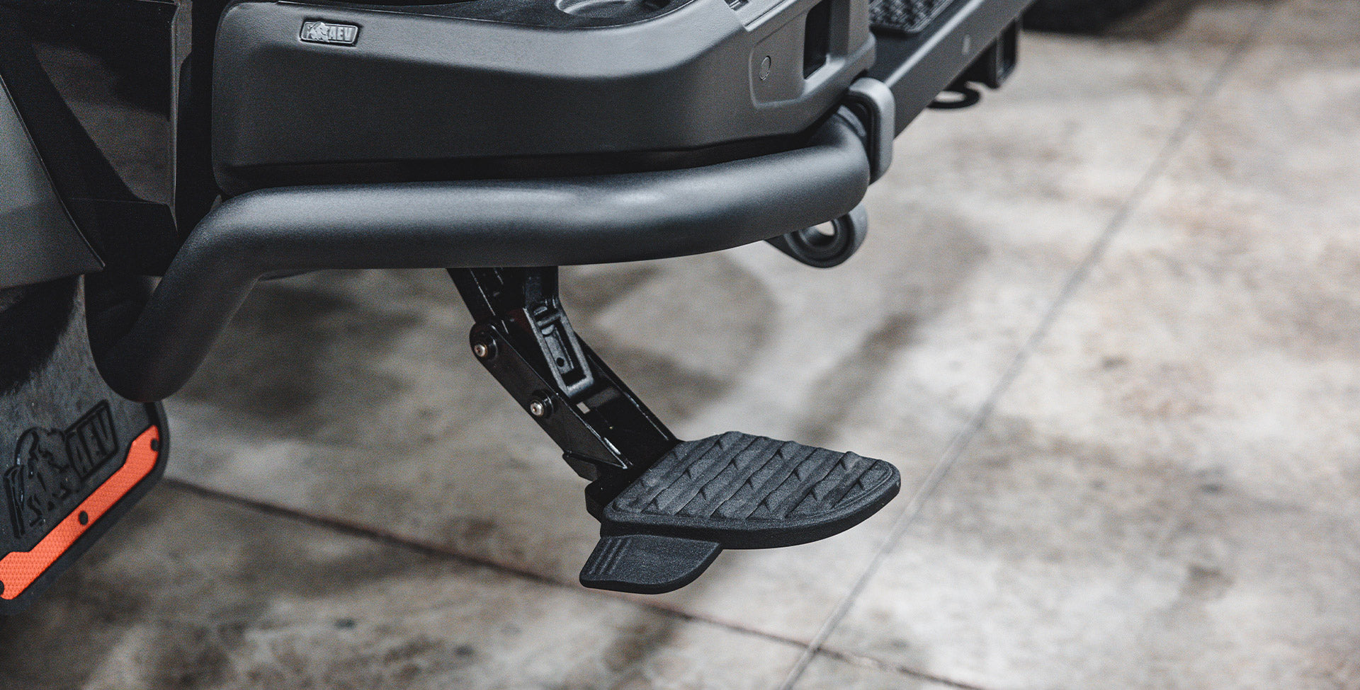 Rear step lowered under rear bumper on vehicle | The Mopar® Bed Step shown in the lowered position