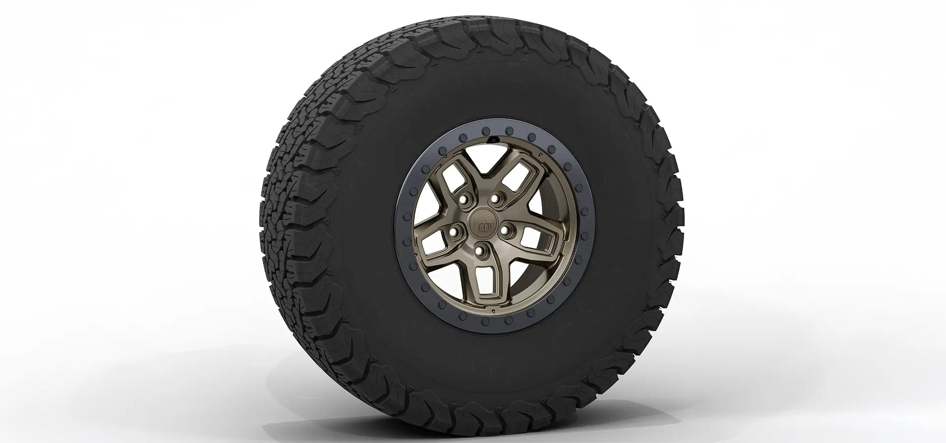Tire with a metallic rim on a white background | Bronze Finish with Onyx Beadlock Ring
