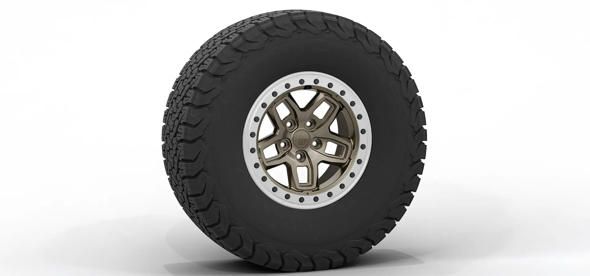 Tire with off-road tread pattern and metallic rim on a white background | Bronze Finish with Silver Protection Ring
