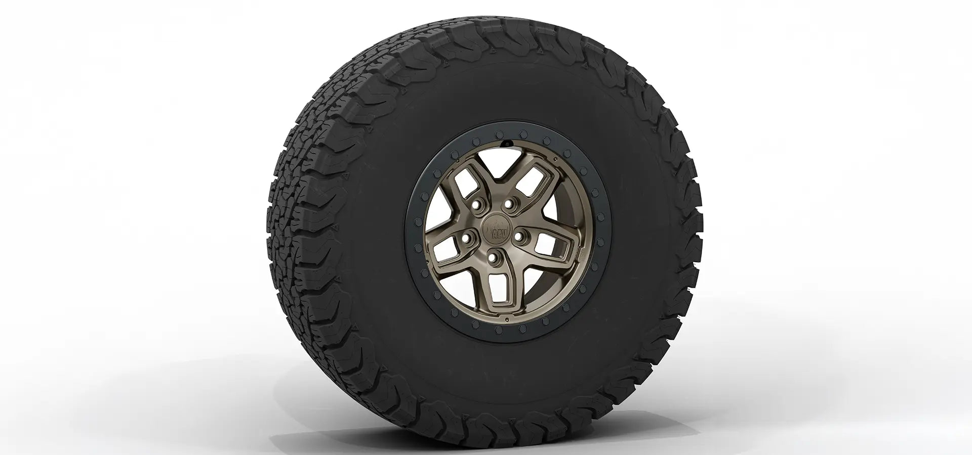 Tire with a rugged tread pattern on a white background | Bronze Finish with Satin Black Beadlock Ring