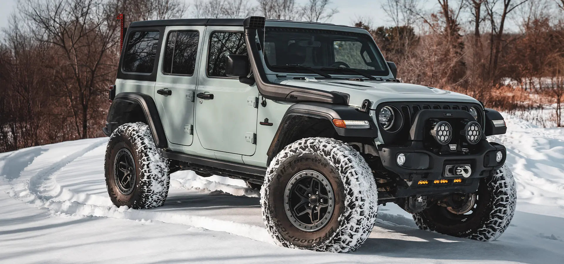 White off-road vehicle with large tires on a snowy landscape | Satin Black Finish with Onyx Protection Ring (+25mm offset)