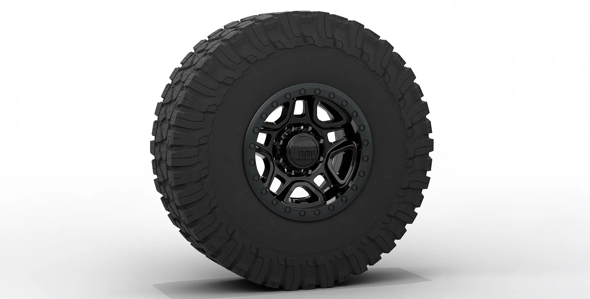 Black off-road tire with a detailed tread pattern on a white background | Gloss Black Finish with Satin Black Beadlock Ring