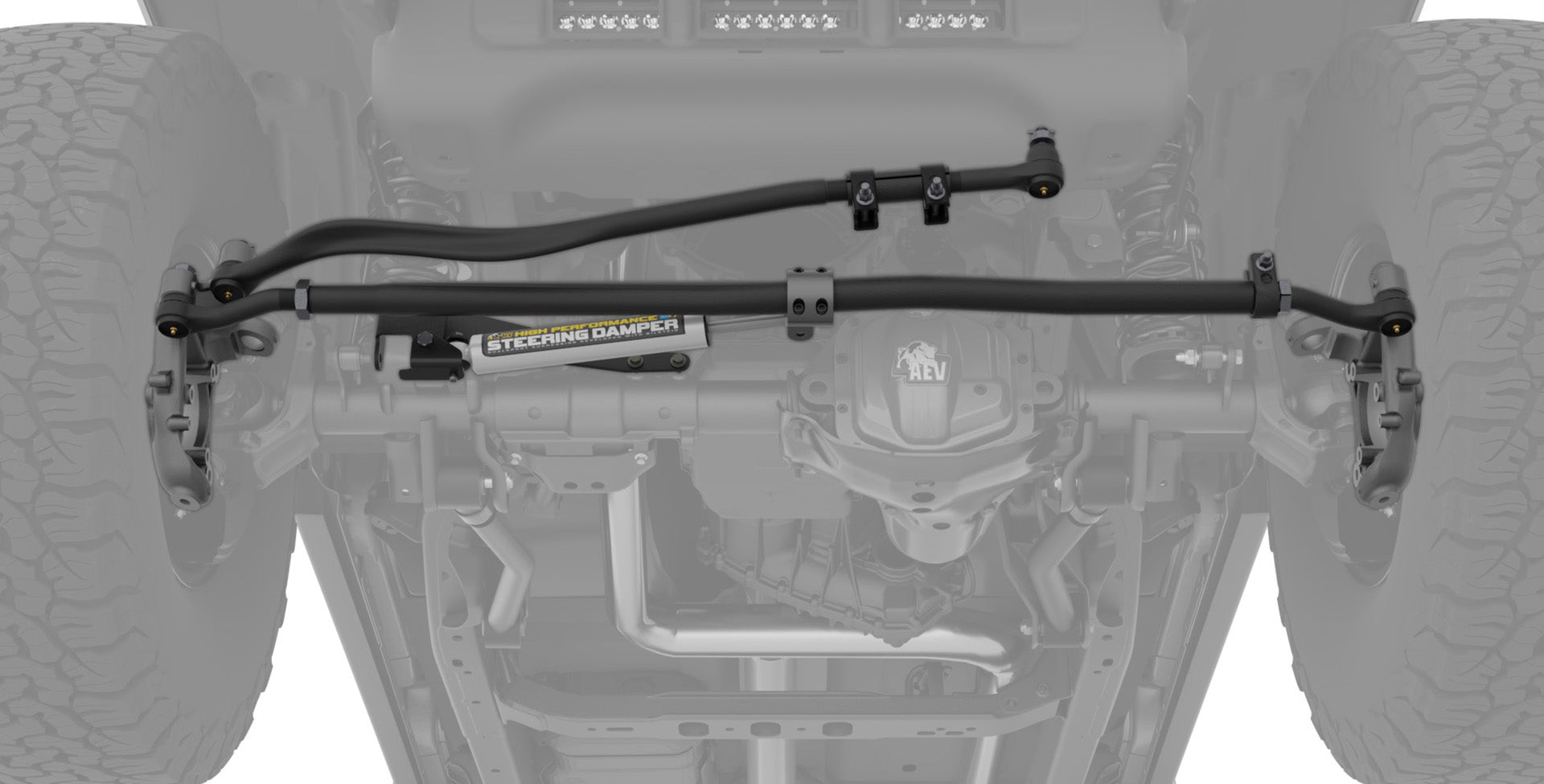 Close-up of a vehicle suspension system with 'AEV' branding. | AEV High Steer Kit with AEV Steering Stabilizer