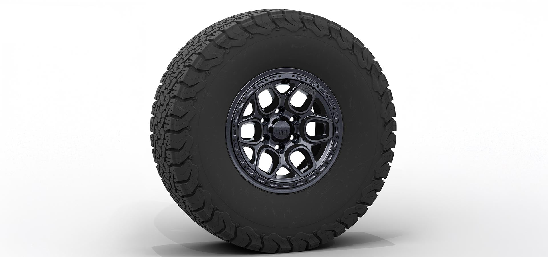 Black off-road tire with a detailed tread pattern on a white background | Onyx Finish with Hardware Kit