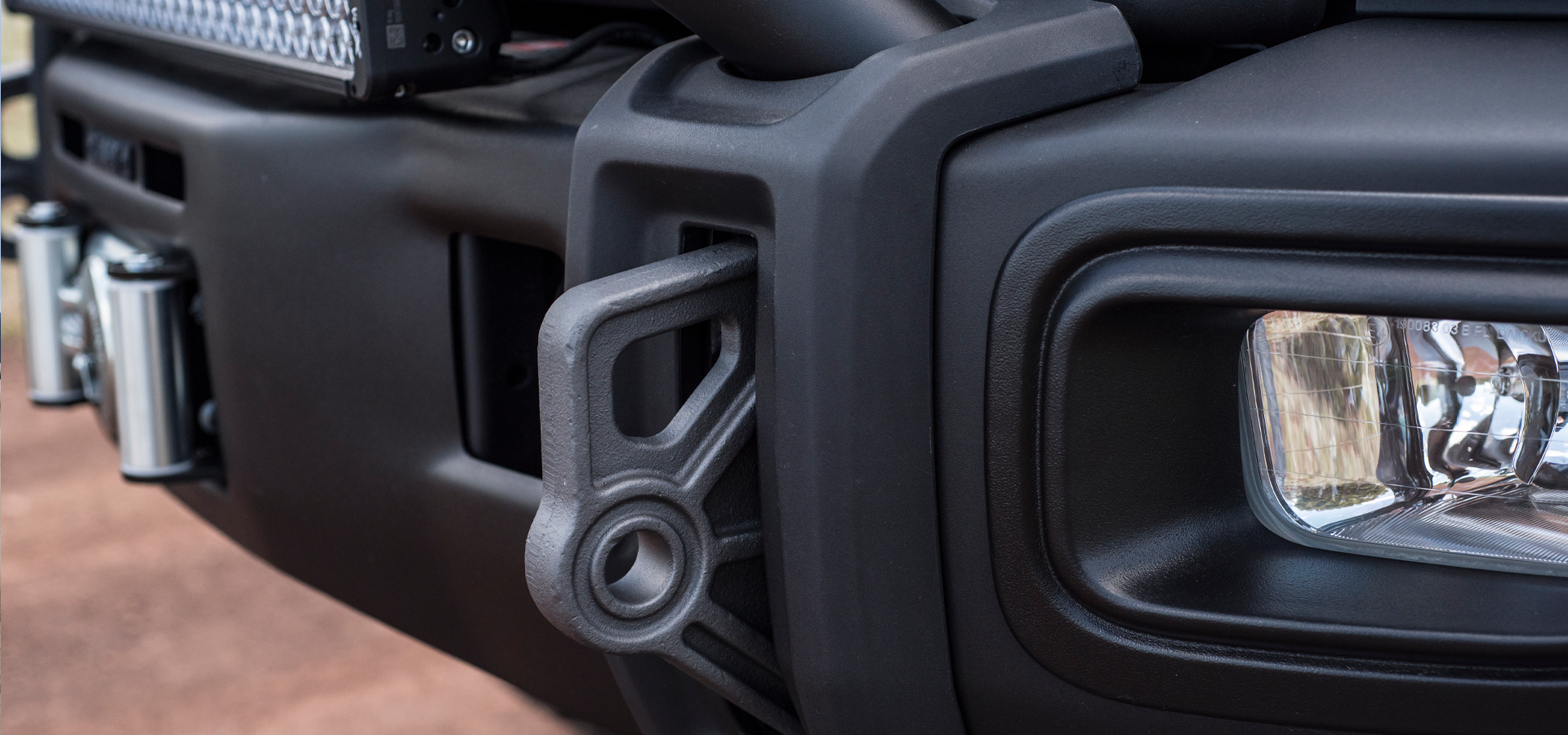 Close-up of a vehicle's front bumper and headlight | w/ OEM Fog Light
