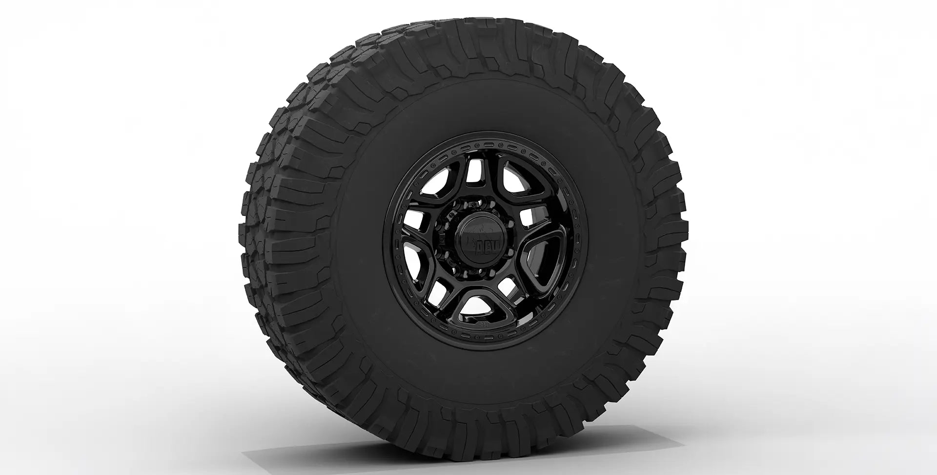 Black off-road tire with a detailed tread pattern on a white background | Gloss Black Finish with Hardware Kit