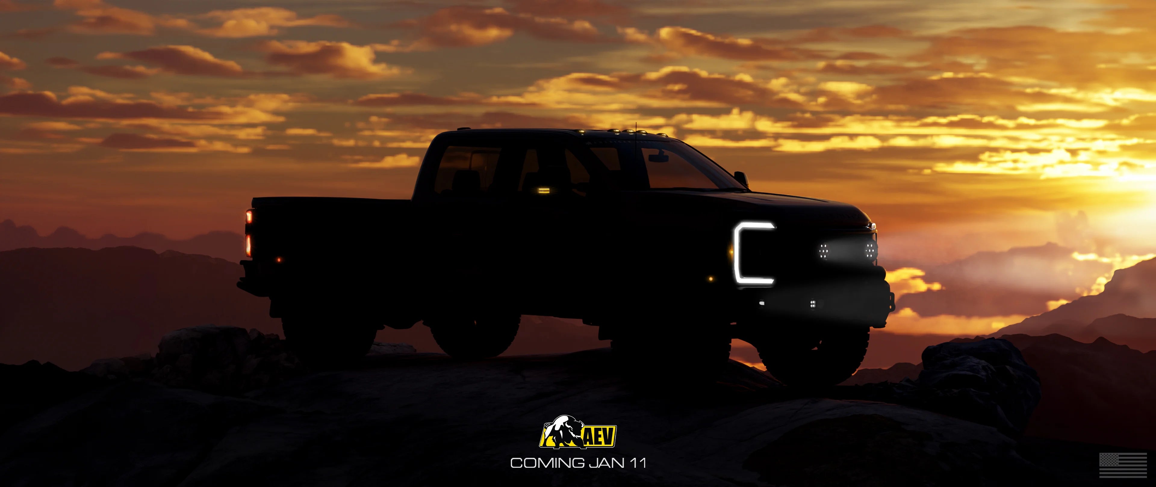 Silhouette of a pickup truck on a rocky landscape with a sunset sky